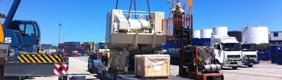 Workers lifting heavy machinery delivered by Moorish Transport Services